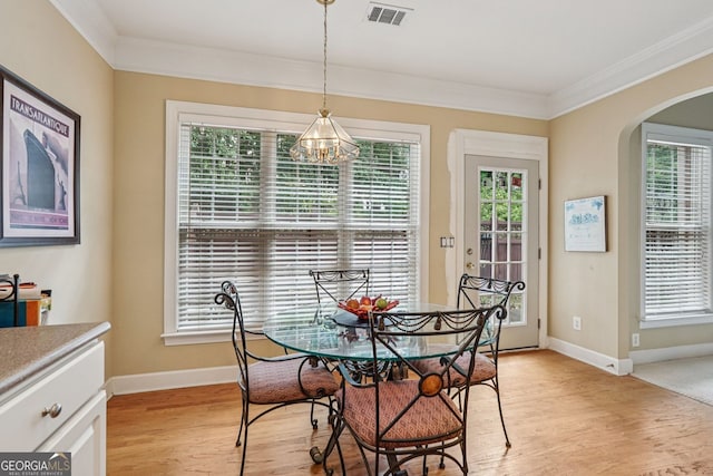 25 Hampreston Ct, Alpharetta, GA 30022 - dining room with arched walkways, a chandelier, ornamental molding, and light wood-style floors