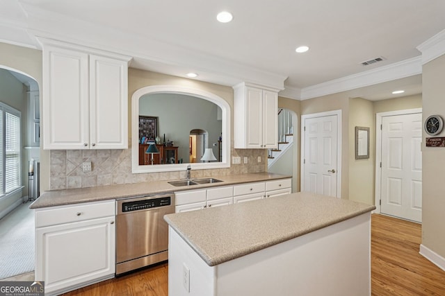 25 Hampreston Ct, Alpharetta, GA 30022 - kitchen with dishwasher, arched walkways, crown molding, a kitchen island, and white cabinets