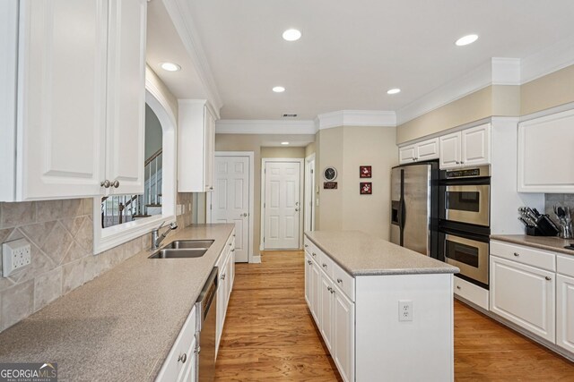 25 Hampreston Ct, Alpharetta, GA 30022 - kitchen featuring appliances with stainless steel finishes, a center island, crown molding, recessed lighting, and white cabinetry