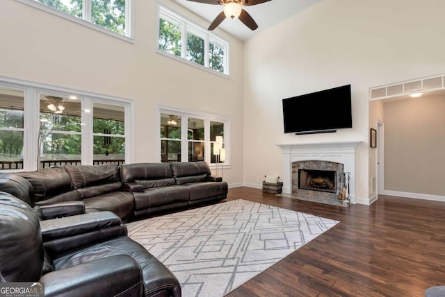 4882 Rabbit Farm Rd, Loganville, GA 30052 - living area with ceiling fan, wood finished floors, a towering ceiling, and a fireplace
