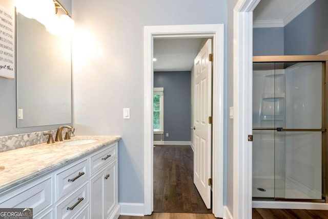 4882 Rabbit Farm Rd, Loganville, GA 30052 - bathroom with vanity, a stall shower, wood finished floors, and crown molding