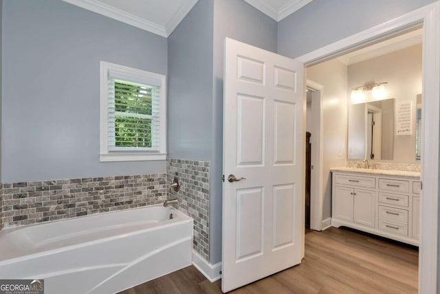 4882 Rabbit Farm Rd, Loganville, GA 30052 - full bath featuring vanity, ornamental molding, a garden tub, and wood finished floors