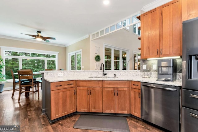 4882 Rabbit Farm Rd, Loganville, GA 30052 - kitchen featuring appliances with stainless steel finishes, ornamental molding, a peninsula, ceiling fan, and light stone counters