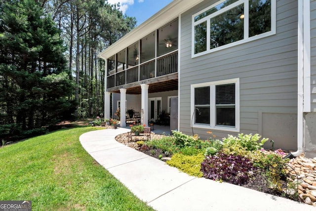 4882 Rabbit Farm Rd, Loganville, GA 30052 - back of house with a patio area, a lawn, and a sunroom