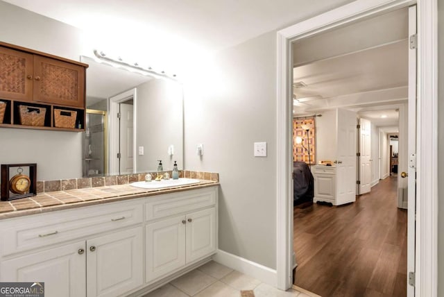 4882 Rabbit Farm Rd, Loganville, GA 30052 - full bathroom featuring vanity, an enclosed shower, ensuite bath, and wood finished floors