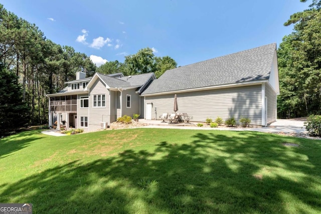 4882 Rabbit Farm Rd, Loganville, GA 30052 - rear view of house featuring a sunroom, a yard, and a chimney