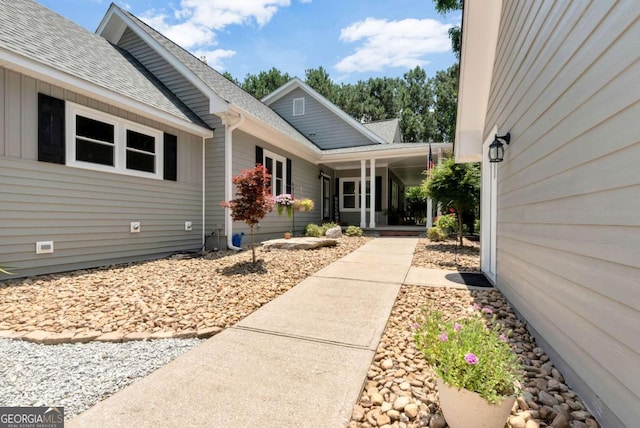 4882 Rabbit Farm Rd, Loganville, GA 30052 - view of exterior entry with a shingled roof and covered porch