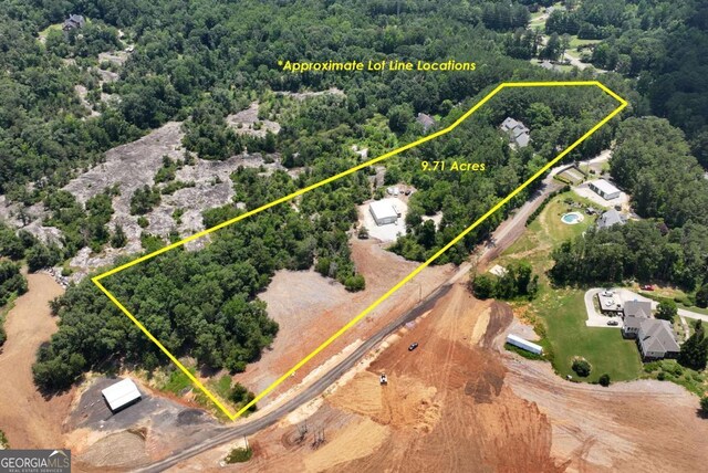 4882 Rabbit Farm Rd, Loganville, GA 30052 - aerial view of property and surrounding area featuring a forest and property parcel outlined