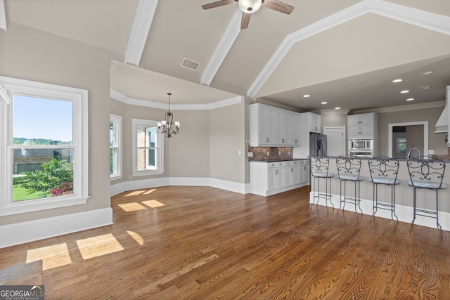 387 Gold Bullion Dr E, Dawsonville, GA 30534 - unfurnished living room with a chandelier, ceiling fan, dark wood-style floors, high vaulted ceiling, and recessed lighting