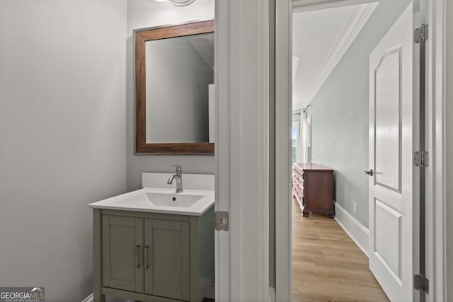 387 Gold Bullion Dr E, Dawsonville, GA 30534 - bathroom with crown molding, vanity, and wood finished floors