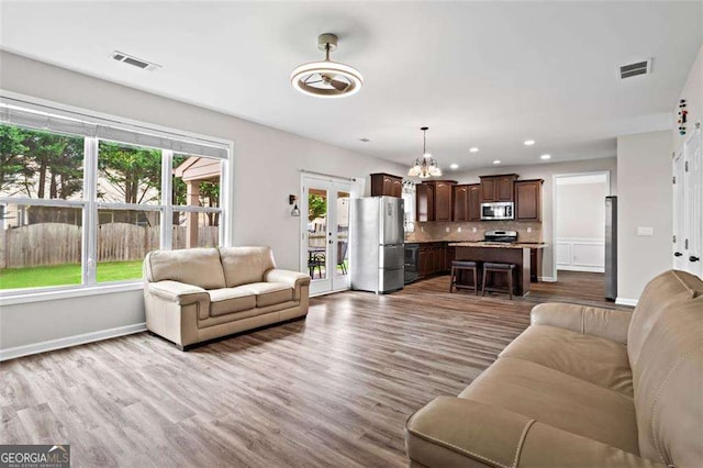 1786 Jameson Cir, Lawrenceville, GA 30043 - living room featuring wood finished floors, a chandelier, and recessed lighting
