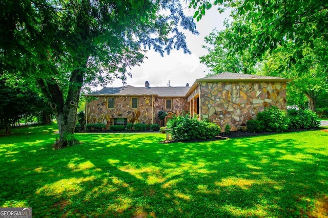 508 College St, Bowdon, GA 30108 - back of house featuring stone siding and a yard