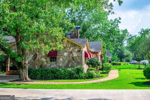 508 College St, Bowdon, GA 30108 - view of side of home with stone siding, a yard, and a shingled roof