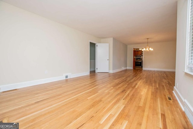 508 College St, Bowdon, GA 30108 - unfurnished room featuring a chandelier and light wood finished floors