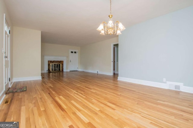 508 College St, Bowdon, GA 30108 - unfurnished living room with a chandelier and light wood finished floors