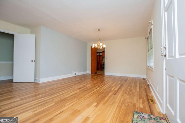 508 College St, Bowdon, GA 30108 - unfurnished room featuring a chandelier and light wood-style flooring