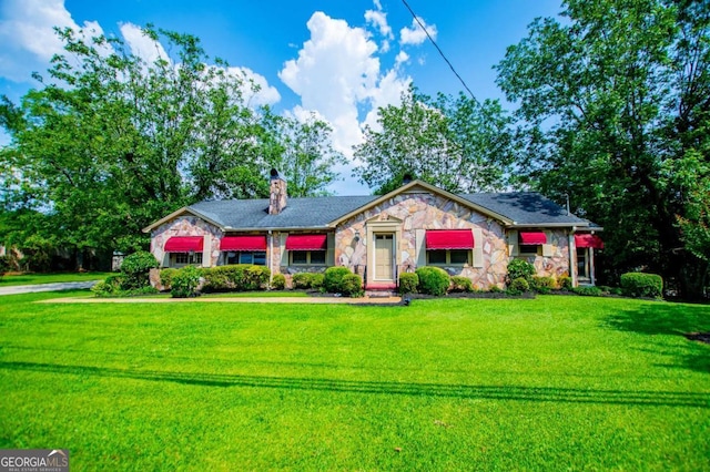 508 College St, Bowdon, GA 30108 - view of front of home featuring stone siding, a front lawn, and a chimney