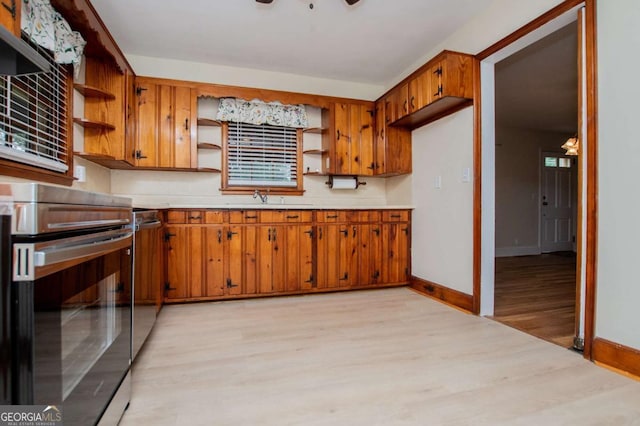 508 College St, Bowdon, GA 30108 - kitchen featuring open shelves, stainless steel electric stove, light wood finished floors, brown cabinets, and light countertops