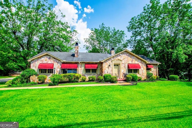 508 College St, Bowdon, GA 30108 - single story home with stone siding, a front yard, and a chimney