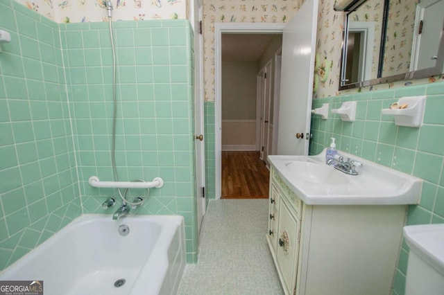 508 College St, Bowdon, GA 30108 - full bathroom with wallpapered walls, a bath, tile walls, vanity, and a shower with door