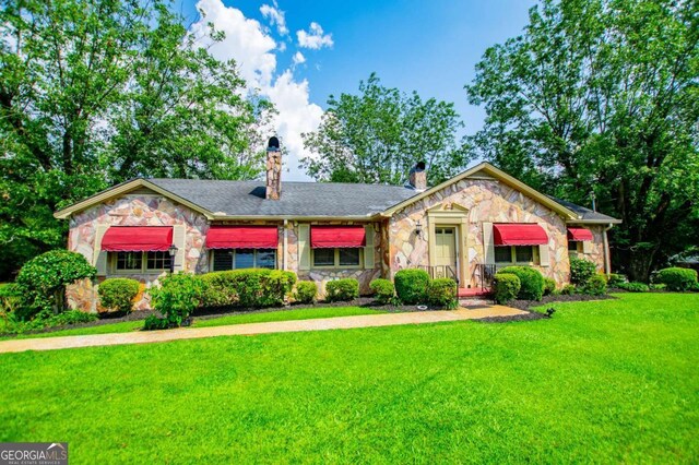 508 College St, Bowdon, GA 30108 - view of front of home with stone siding, a front lawn, and a chimney