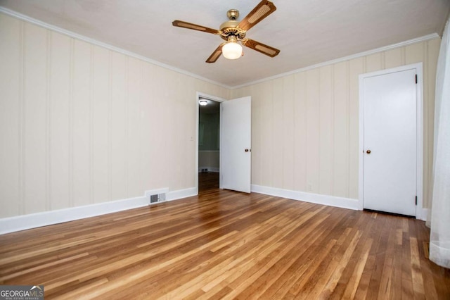 508 College St, Bowdon, GA 30108 - spare room with hardwood / wood-style flooring, crown molding, and a ceiling fan