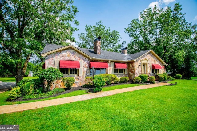 508 College St, Bowdon, GA 30108 - view of front of house featuring stone siding, a chimney, and a front lawn
