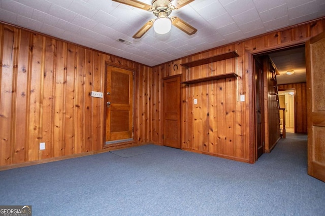 508 College St, Bowdon, GA 30108 - carpeted spare room with wood walls and a ceiling fan