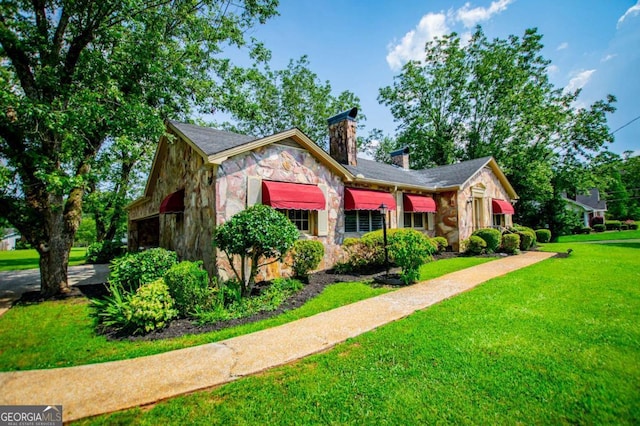 508 College St, Bowdon, GA 30108 - view of front of property with stone siding, a chimney, and a front lawn