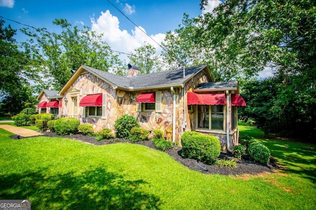 508 College St, Bowdon, GA 30108 - view of front of house featuring stone siding, a front yard, and a chimney