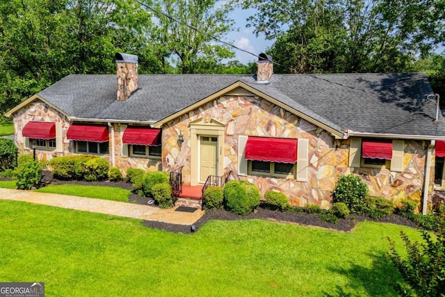 508 College St, Bowdon, GA 30108 - view of front of property featuring stone siding, a chimney, and a front yard