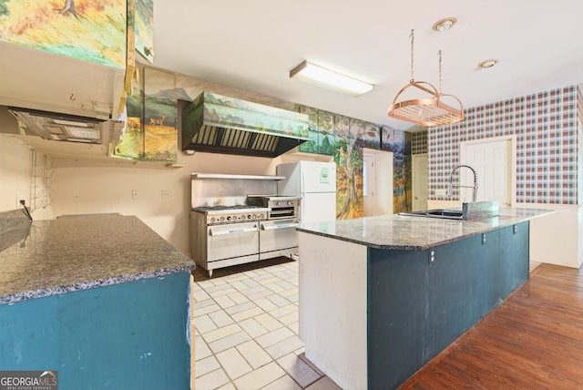 290 Bear Cave Trl, Lakemont, GA 30552 - kitchen with wallpapered walls, double oven range, exhaust hood, dark stone counters, and an island with sink