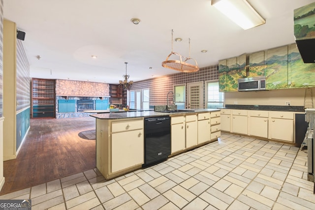 290 Bear Cave Trl, Lakemont, GA 30552 - kitchen featuring black dishwasher, stainless steel microwave, cream cabinetry, open floor plan, and dark countertops