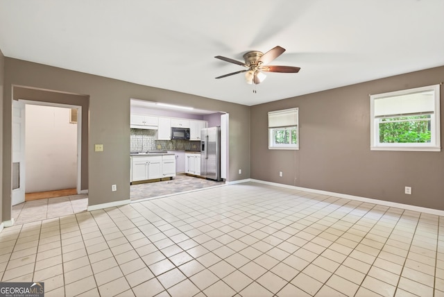 290 Bear Cave Trl, Lakemont, GA 30552 - unfurnished living room featuring ceiling fan and light tile patterned floors