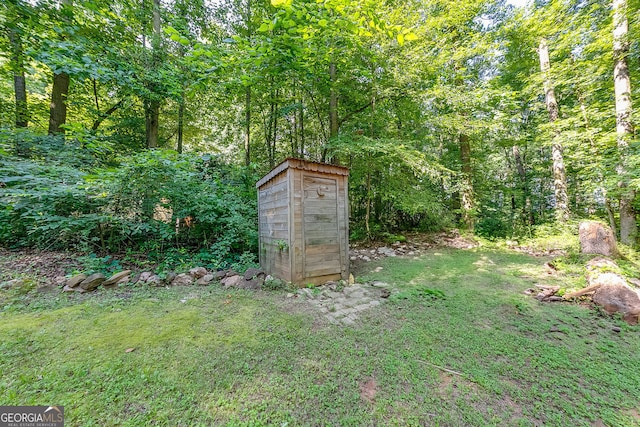 950 Jefferson River Rd, Jefferson, GA 30549 - view of grassy yard featuring a storage shed and a wooded view