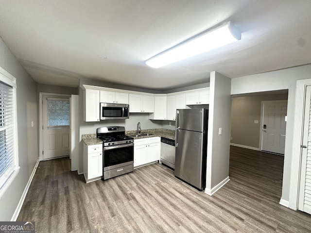 3645 Croft Pl NW, Atlanta, GA 30331 - kitchen with stainless steel appliances, wood finished floors, white cabinets, and light stone countertops