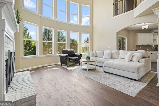 6665 Flagstone Ct, Cumming, GA 30028 - living room with a towering ceiling, dark wood-type flooring, and arched walkways