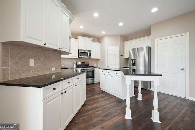 6665 Flagstone Ct, Cumming, GA 30028 - kitchen with appliances with stainless steel finishes, white cabinetry, dark countertops, and recessed lighting