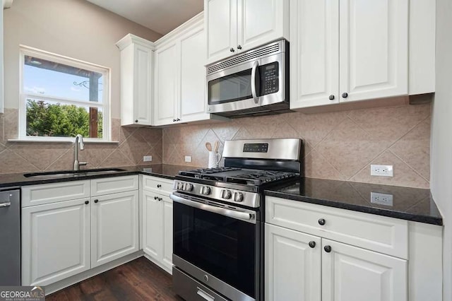 6665 Flagstone Ct, Cumming, GA 30028 - kitchen with stainless steel appliances, white cabinets, backsplash, and dark wood-style floors
