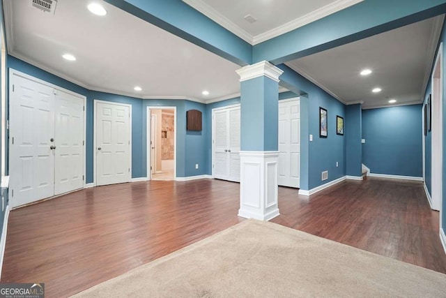 6665 Flagstone Ct, Cumming, GA 30028 - foyer entrance featuring ornate columns, ornamental molding, wood finished floors, and recessed lighting