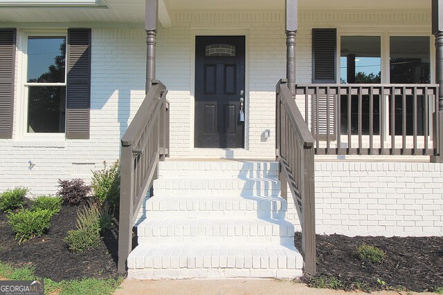 413 Spring Village Rd SE, Lindale, GA 30147 - doorway to property with covered porch and brick siding
