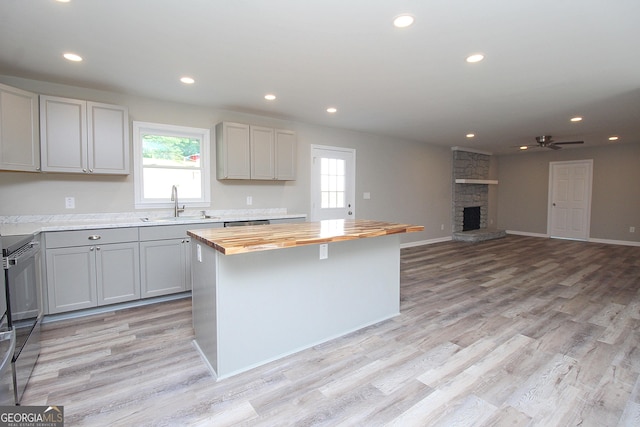 413 Spring Village Rd SE, Lindale, GA 30147 - kitchen featuring butcher block counters, plenty of natural light, gray cabinetry, light wood-type flooring, and recessed lighting