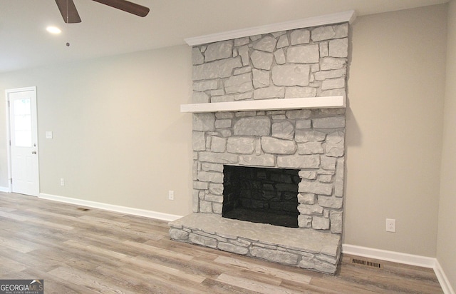 413 Spring Village Rd SE, Lindale, GA 30147 - unfurnished living room featuring ceiling fan, wood finished floors, and a fireplace