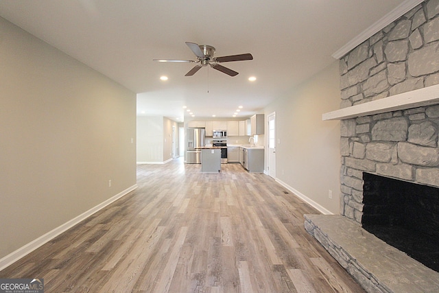 413 Spring Village Rd SE, Lindale, GA 30147 - unfurnished living room featuring a ceiling fan, recessed lighting, light wood-style flooring, and a fireplace