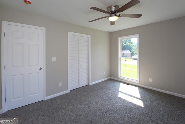 413 Spring Village Rd SE, Lindale, GA 30147 - unfurnished bedroom with carpet flooring, a closet, and a ceiling fan