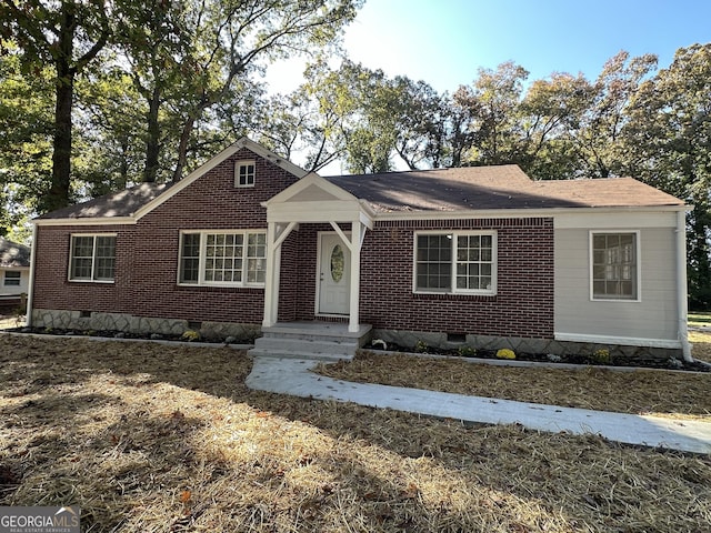 718 N Hairston Rd, Stone Mountain, GA 30083 - view of front facade with crawl space, a shingled roof, and brick siding