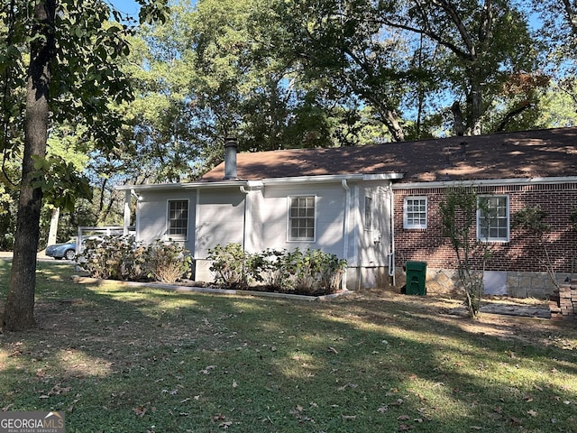 718 N Hairston Rd, Stone Mountain, GA 30083 - view of property exterior with a lawn and brick siding