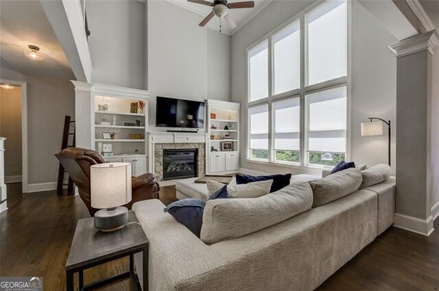 6863 Lake Sterling, Flowery Branch, GA 30542 - living area featuring a fireplace, a ceiling fan, dark wood-style floors, high vaulted ceiling, and decorative columns