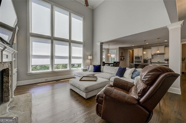6863 Lake Sterling, Flowery Branch, GA 30542 - living area featuring plenty of natural light, decorative columns, a high ceiling, ornamental molding, and a fireplace