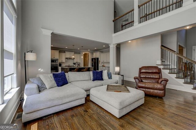 6863 Lake Sterling, Flowery Branch, GA 30542 - living area with a high ceiling, plenty of natural light, dark wood finished floors, and stairway